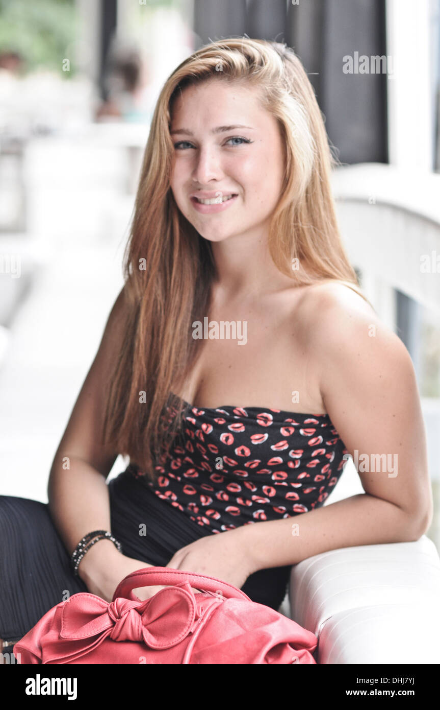 Woman sitting on bar Stock Photo