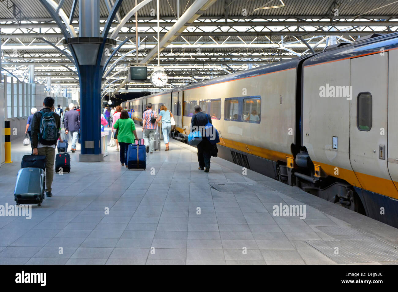 Brussels Midi Zuid station platform passengers pulling wheeled suitcase luggage leaving EuroStar train from London walking towards exit in Belgium Stock Photo