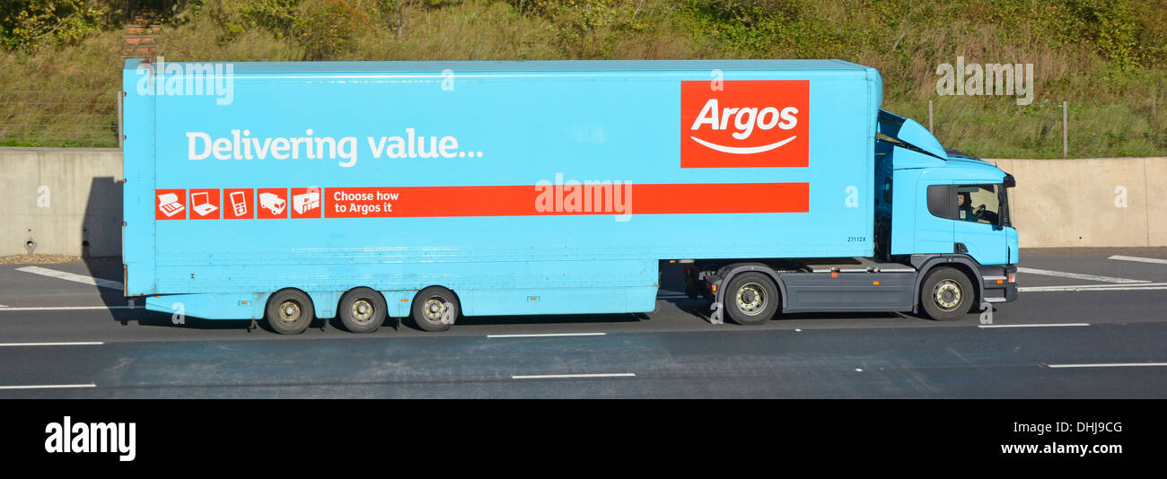 Argos delivery trailer and truck driving along motorway Stock Photo