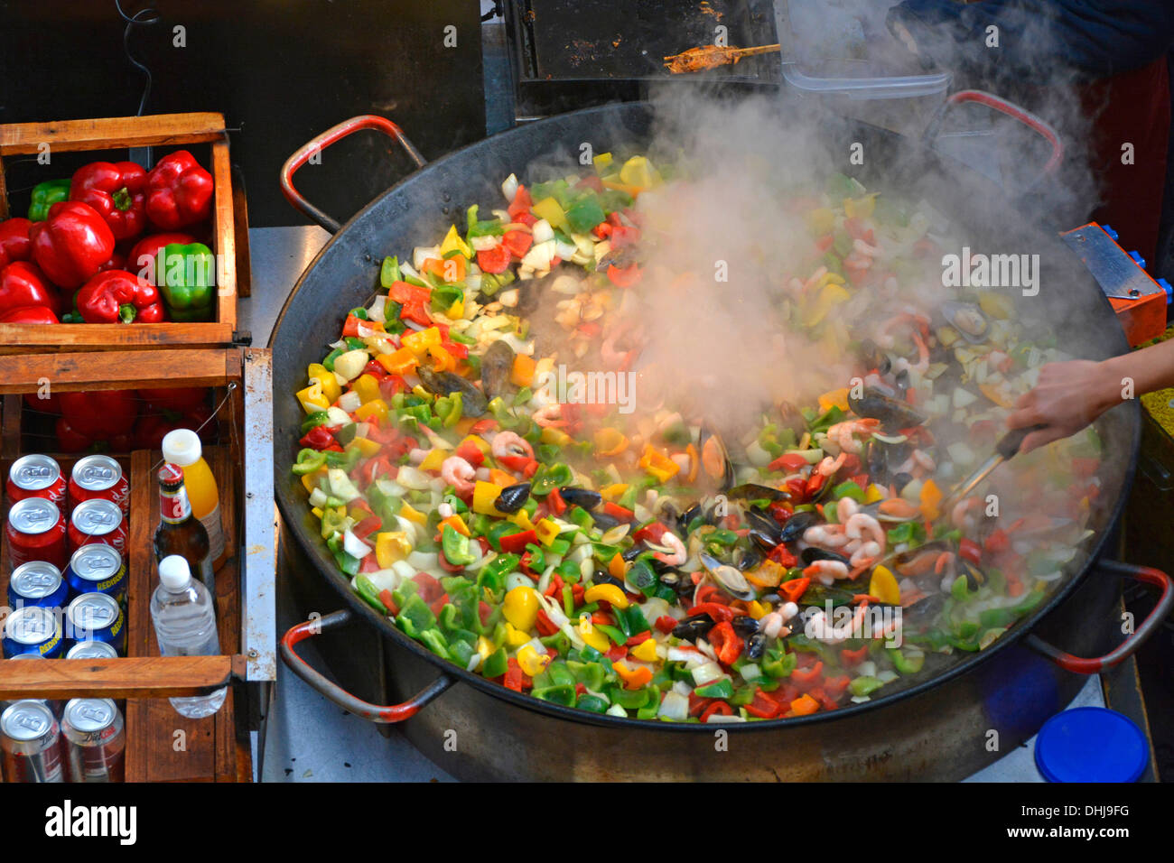 Very large pan of Paella cooking at a cafe stall in Covent Garden London England UK Stock Photo
