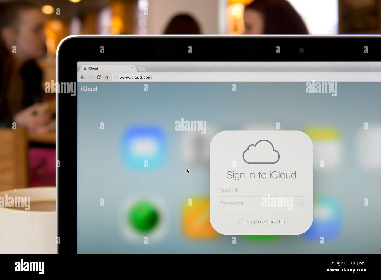 The iCloud logo as seen on the Apple website shot in a coffee shop environment (Editorial use only). Stock Photo