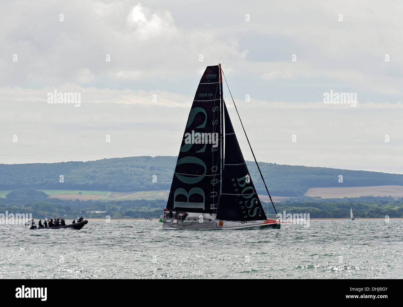 Fastnet yacht race 2013. Racing yacht sailing down the Solent after the start from Cowes. Competing Transat Jacques Vabre 2013. Stock Photo