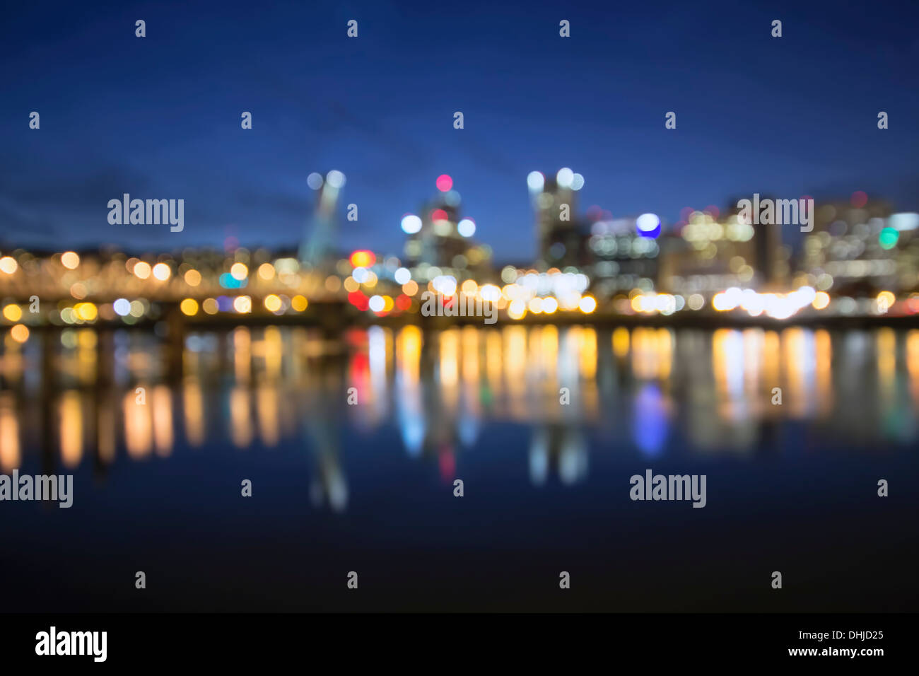 Out of Focus Portland Oregon Skyline with Hawthorne Bridge and Willamette River City Lights Reflection at Blue Hour Stock Photo