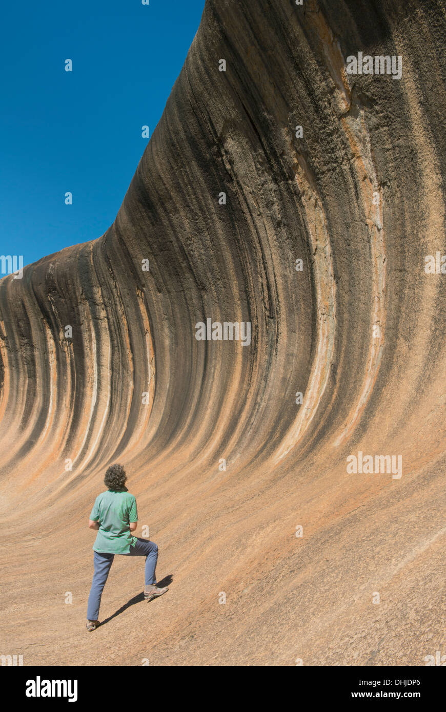 Wave Rock, geological attraction, Hyden, Western Australia, with woman viewer Stock Photo
