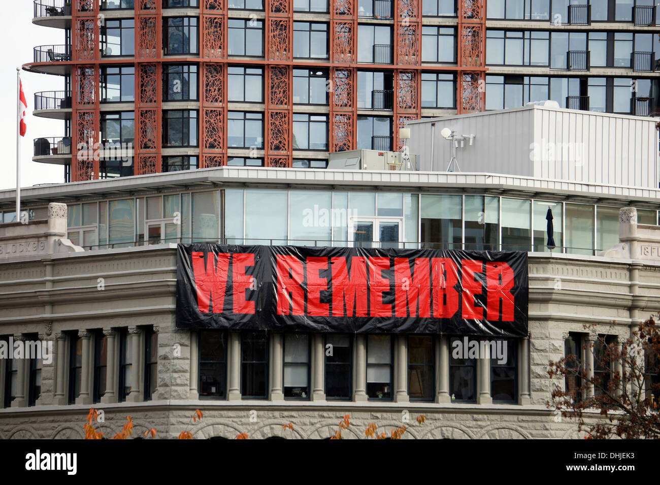 A banner hangs from a building during Remembrance Day ceremonies in Victory Square in downtown Vancouver, British Columbia, Canada Stock Photo