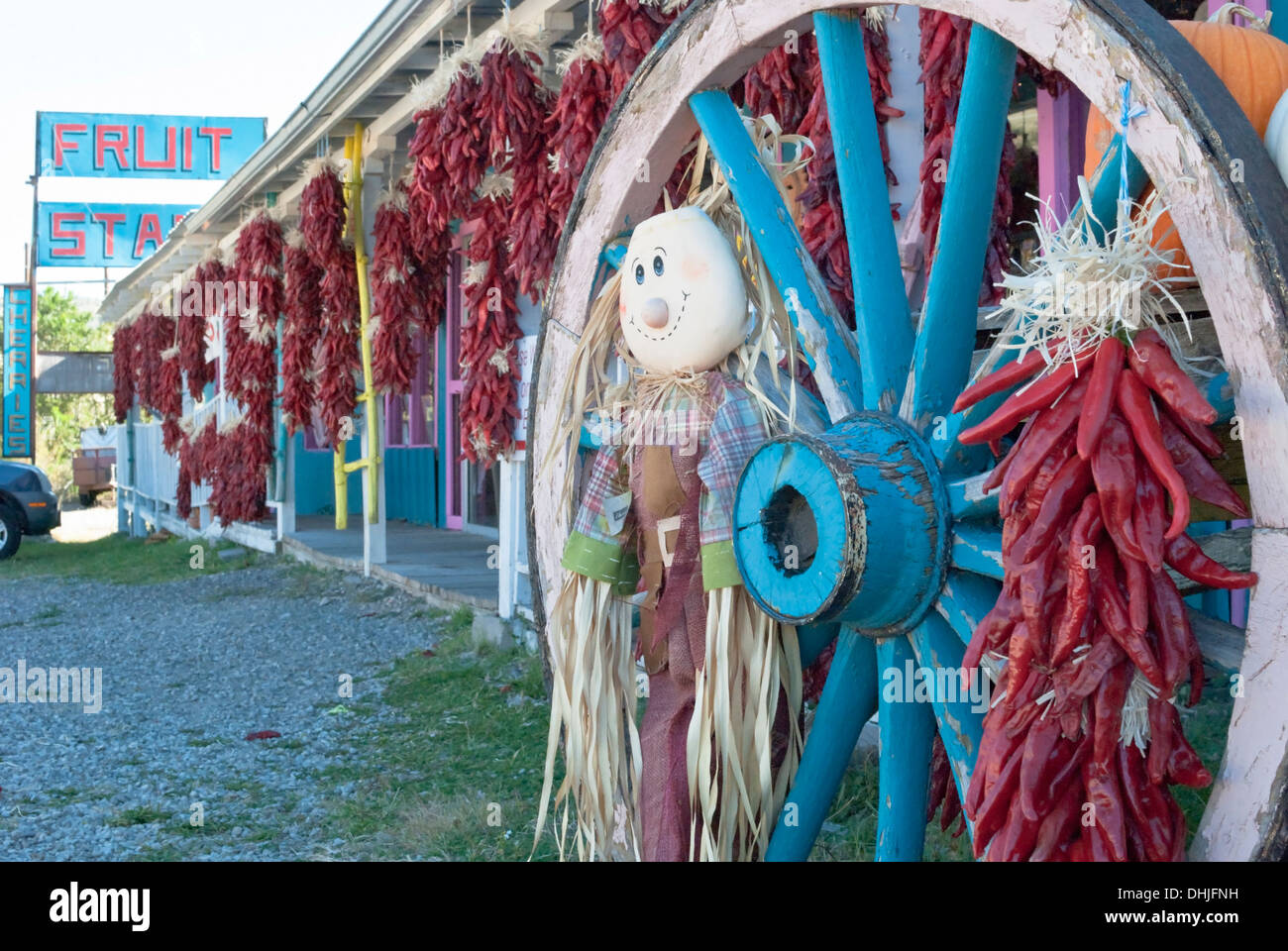 One of many fruit stands along Route 70 in the Hondo Valley is covered with chili ristras. Stock Photo