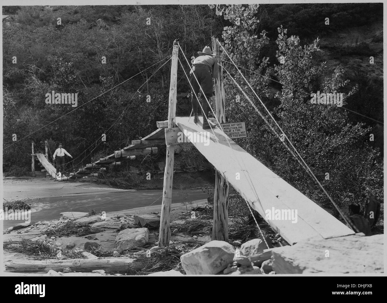 Mr. Arthur Newton Pack, of Nature Magazine, taking motion picture of Mr. Brian on suspension bridge in front of Zion. 520556 Stock Photo