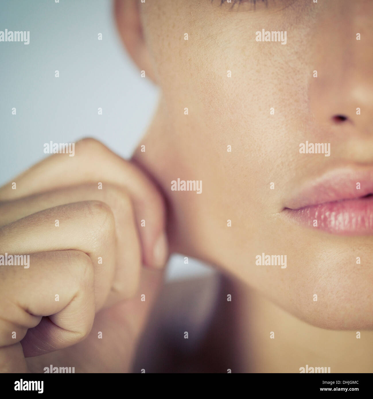 A young woman stretching the skin on her face Stock Photo