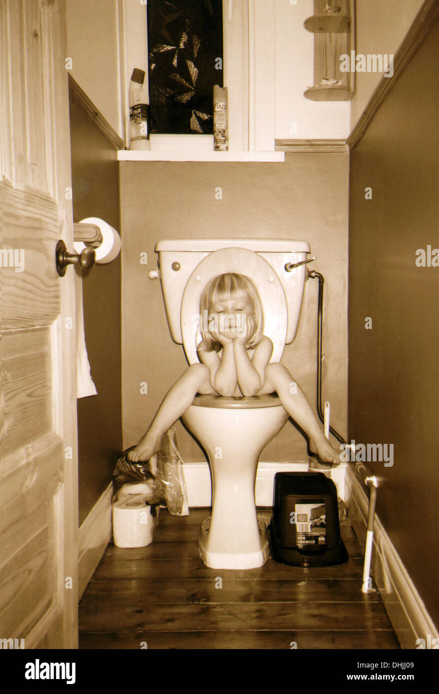 Sleeping on the loo. Stock Photo