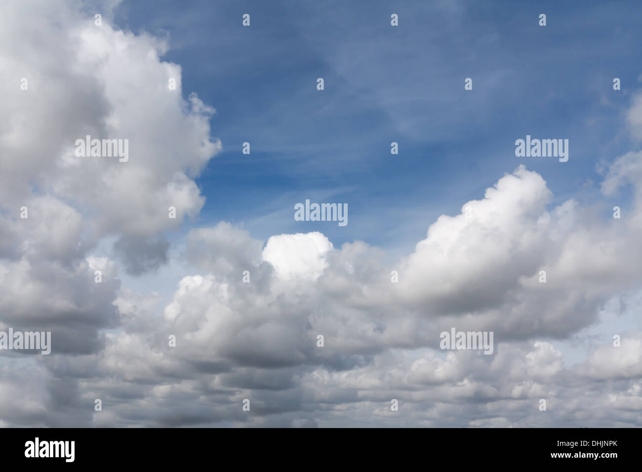 blue sky with white fluffy and wispy clouds Stock Photo - Alamy