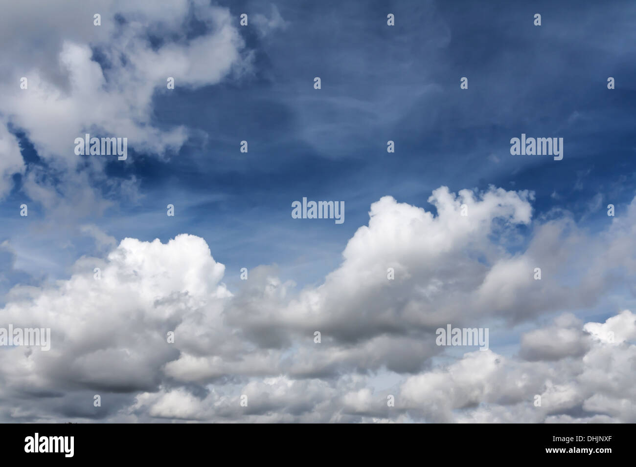 bright blue sky with white wispy clouds Stock Photo - Alamy