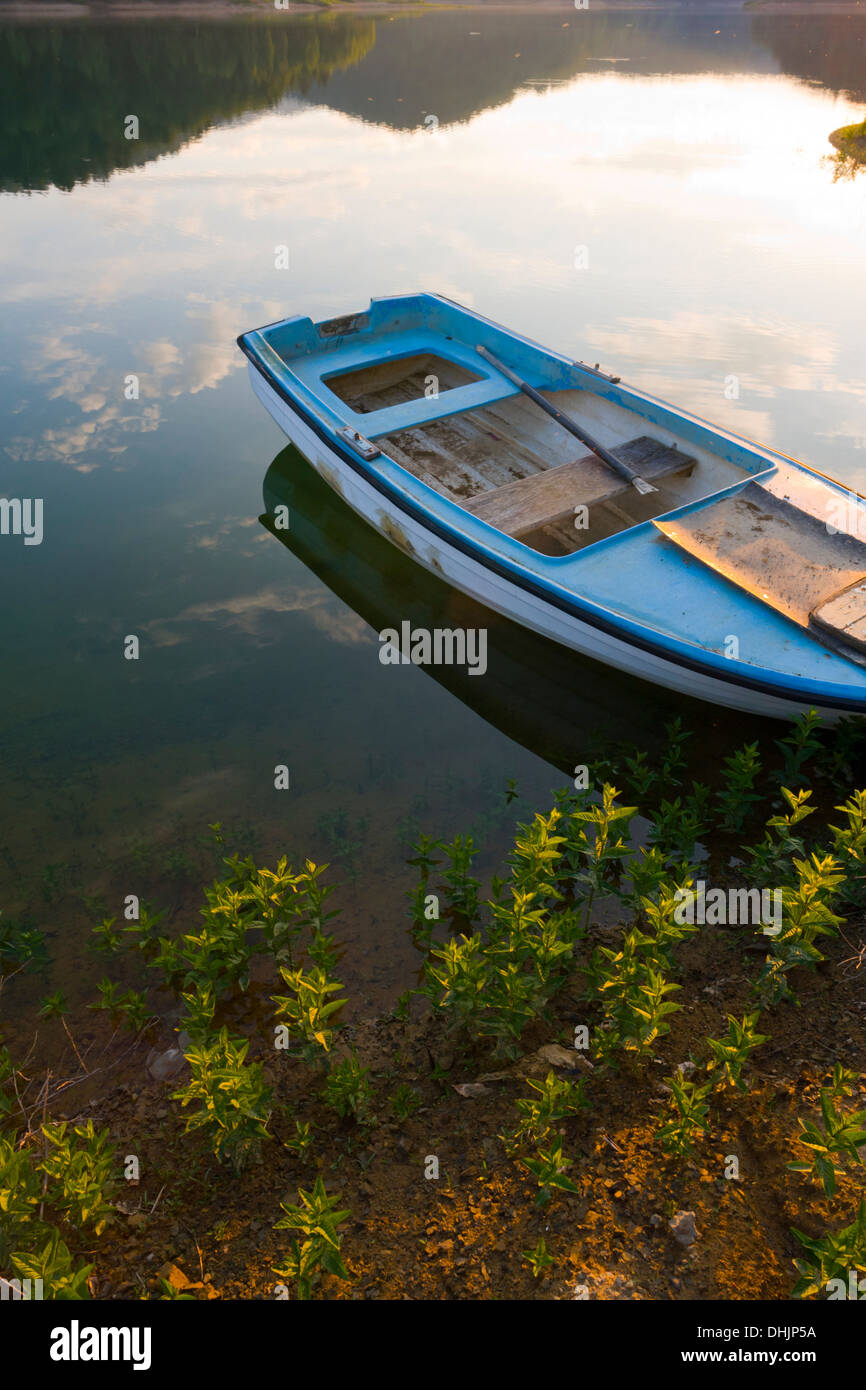 Peaceful lake surface moored boat Stock Photo