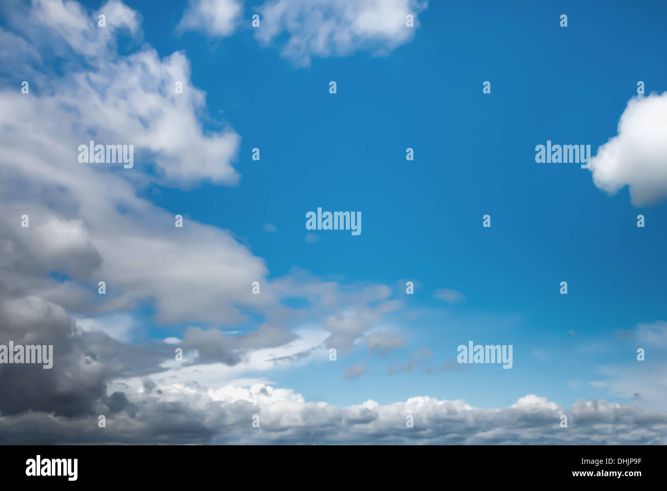 bright blue sky with white grey clouds Stock Photo - Alamy