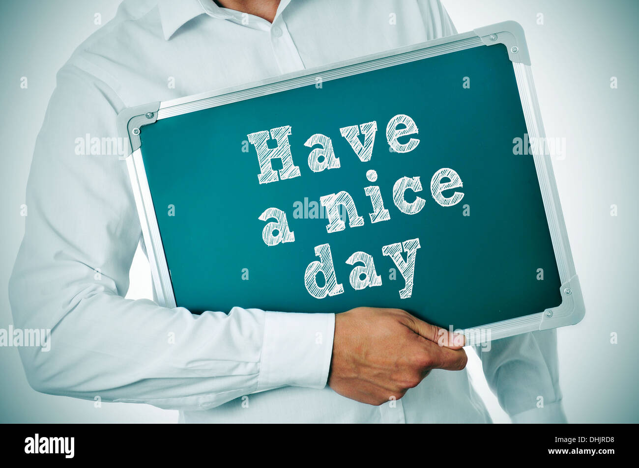 man holding a chalkboard with the sentence have a nice day written in it Stock Photo