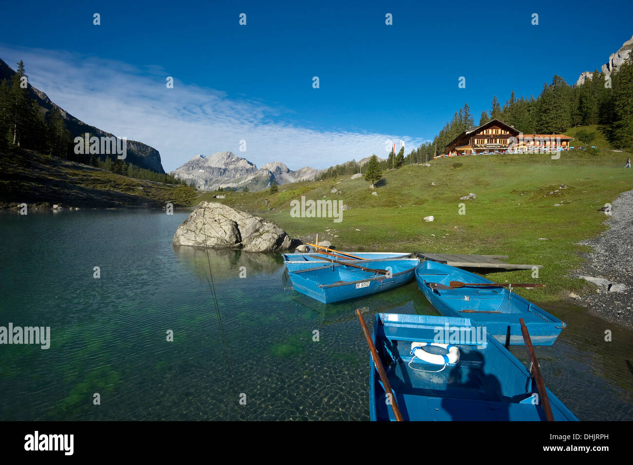 Rowing boats and guesthouse at lake Oeschinensee, Kandersteg, Bernese Oberland, Canton of Bern, Switzerland, Europe Stock Photo