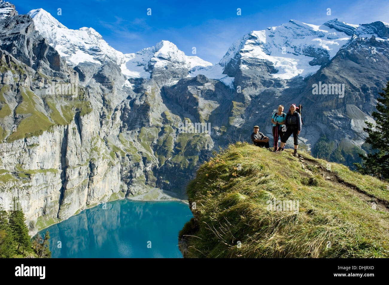 Hikers at lake Oeschinensee, Kandersteg, Bernese Oberland, Canton of Bern, Switzerland, Europe Stock Photo