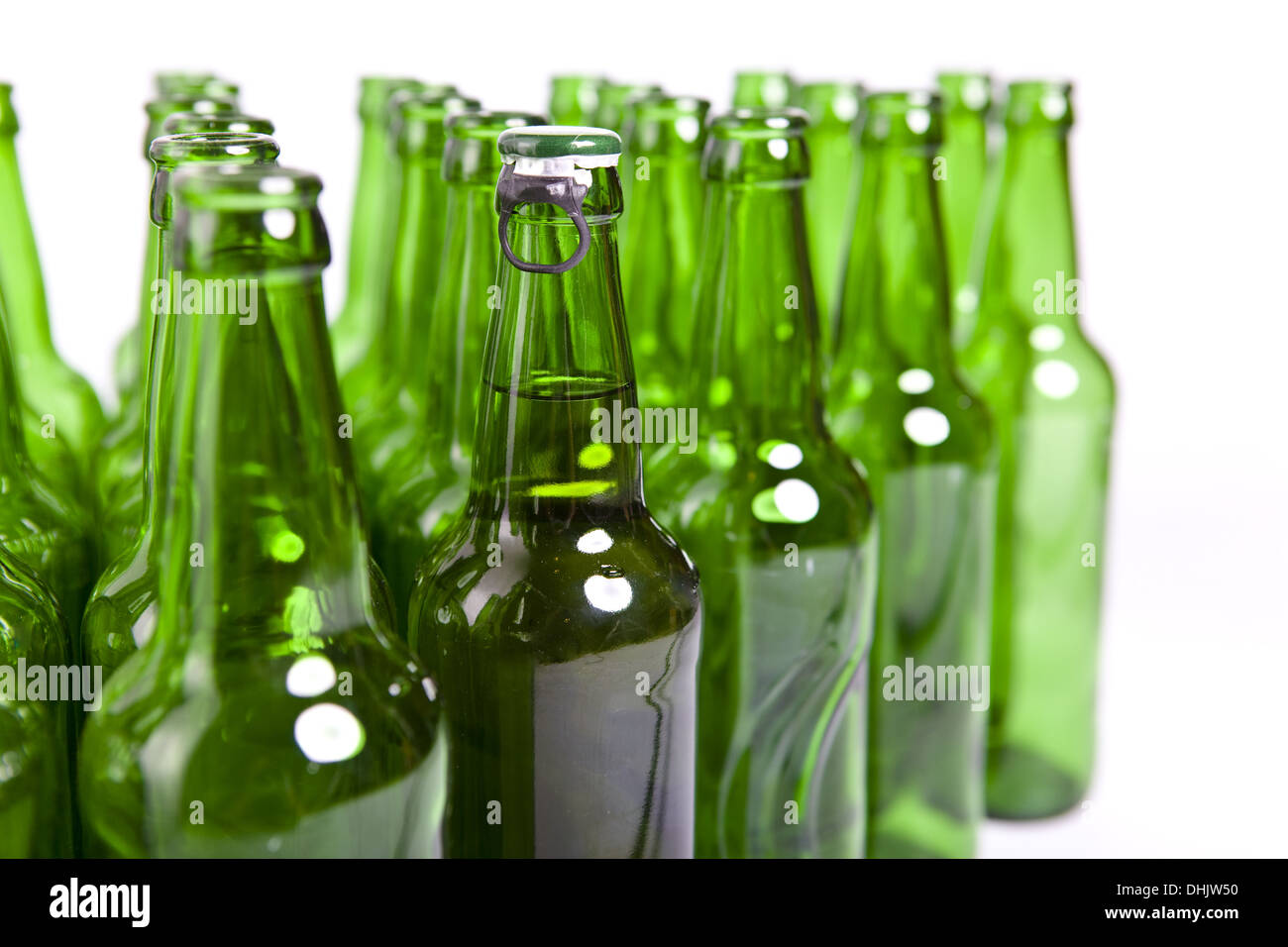 Empty glass bottles and one full Stock Photo Alamy