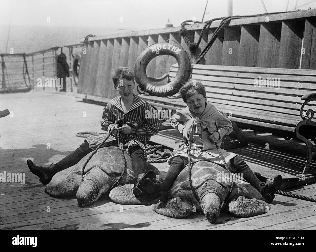 View of the sun deck with two children riding green sea turtles (Chelonia mydas) on the ocean liner 'Moltke' of Hapag Hamburg, Blohm und Voss Hamburg, shipyard 1901, photograph taken around 1910. The image was taken by the German photographer Oswald Lübeck, one of the earliest representatives of travel photography and ship photography aboard passenger ships. Photo: Deutsche Fotothek/Oswald Lübeck Stock Photo