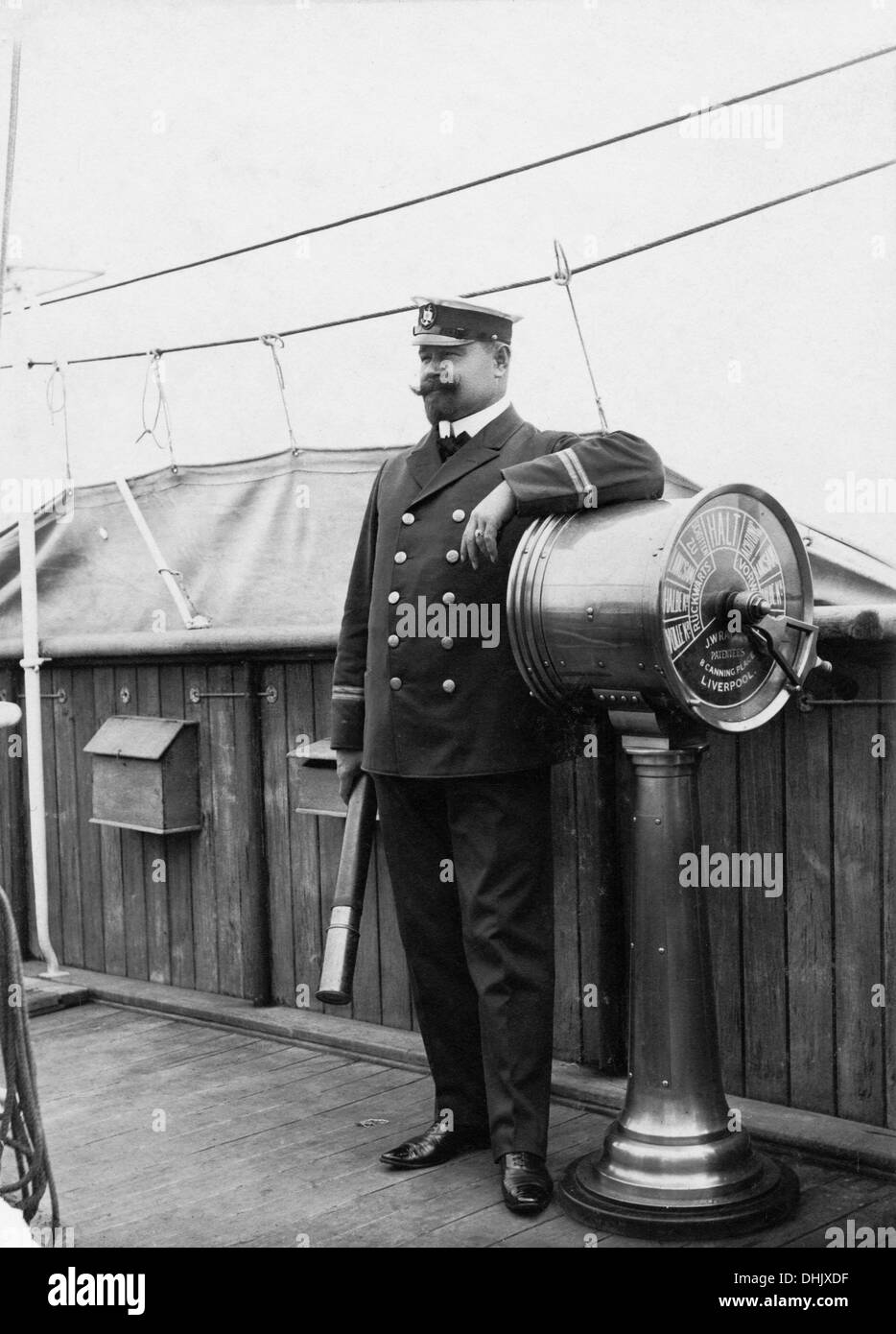 An officer is pictured with binoculars on the bridge of a passenger ship on international waters, undated photograph (around 1912). The image was taken by the German photographer Oswald Lübeck, one of the earliest representatives of travel photography and ship photography aboard passenger ships. Photo: Deutsche Fotothek/Oswald Lübeck Stock Photo