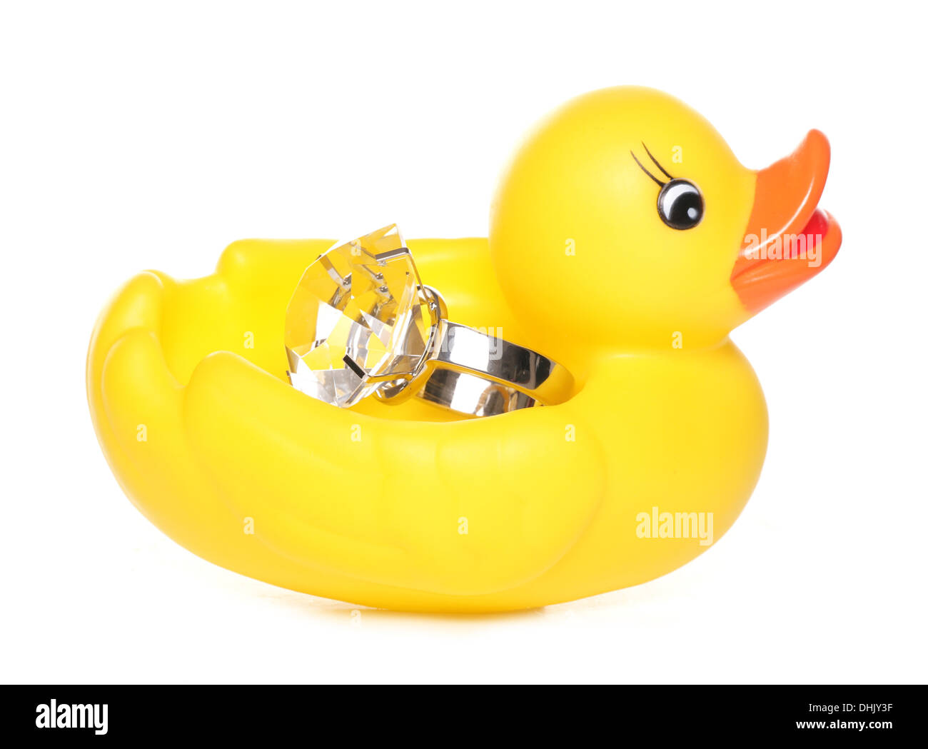 Yellow rubber duck holding a diamond ring studio cutout Stock Photo