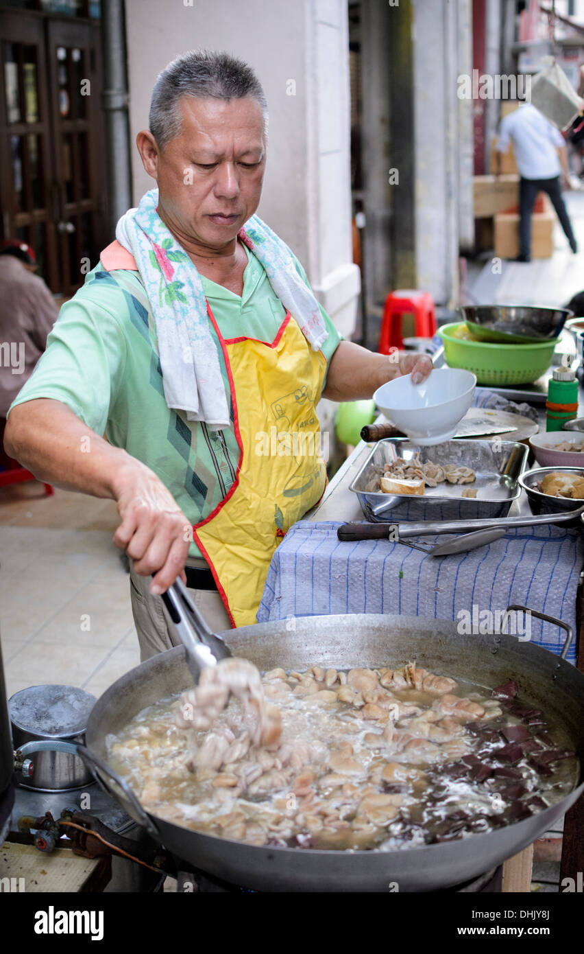 Street vendor on a South East Asian street stall, selling boiled tripe (intestines) Stock Photo
