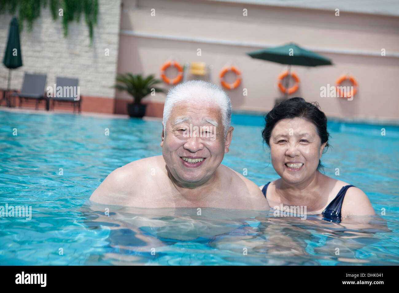 Portrait of senior couple relaxing in the pool Stock Photo - Alamy