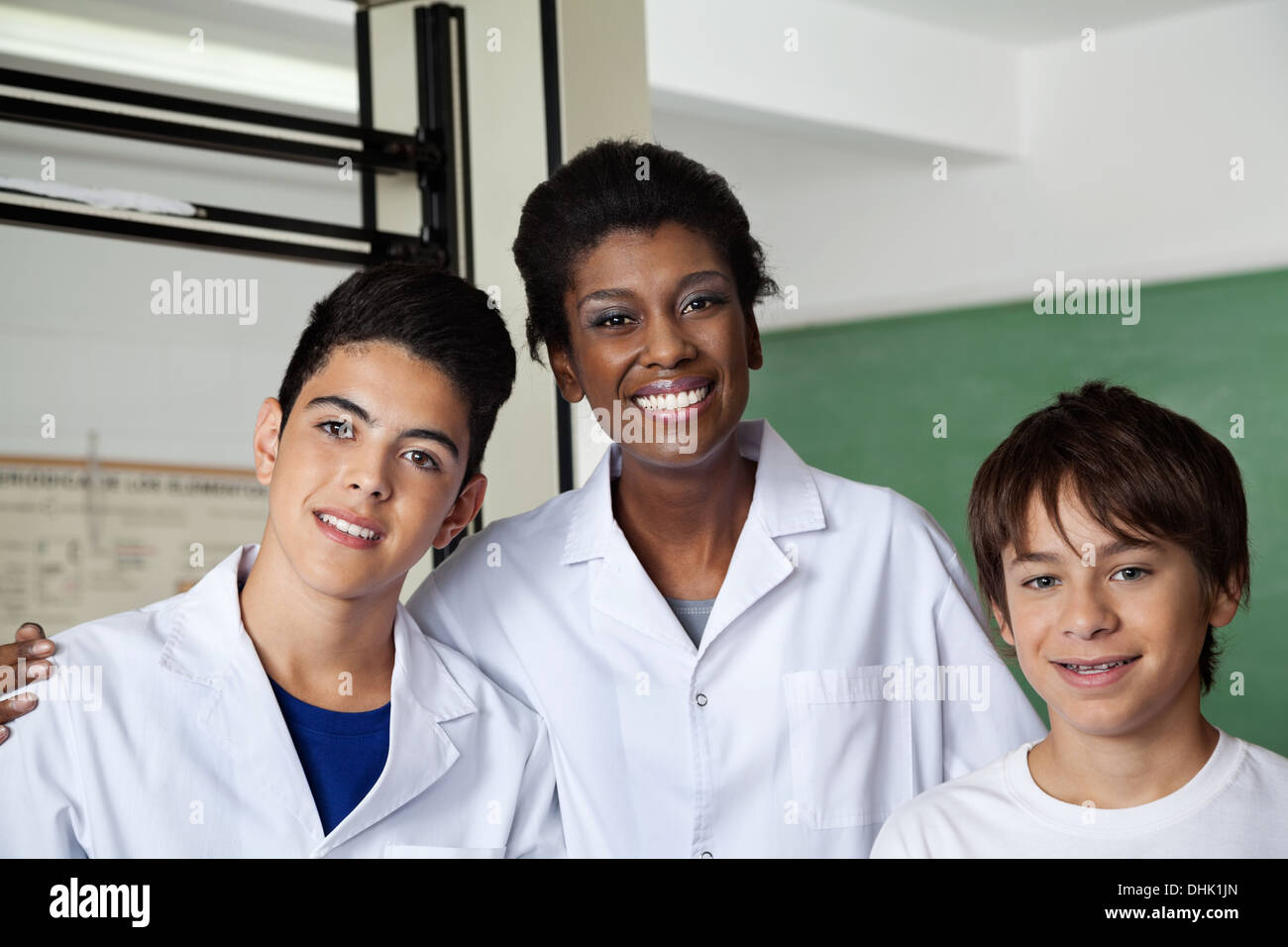 Teacher And Schoolboys Standing Together In Science Lab Stock Photo