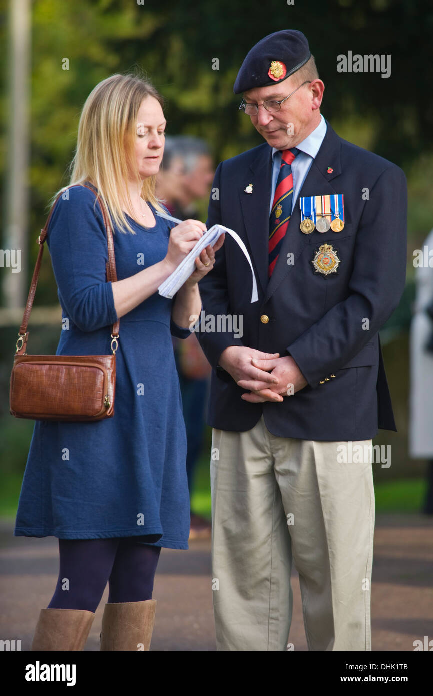Army veteran being interviewed by newspaper reporter on Remembrance ...