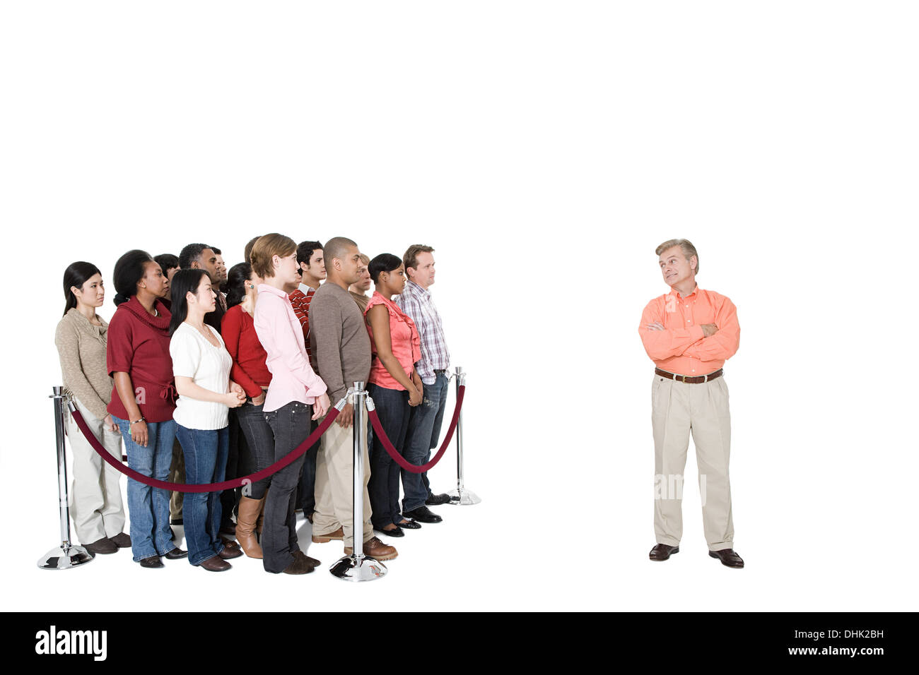 A mature man standing out from the crowd Stock Photo