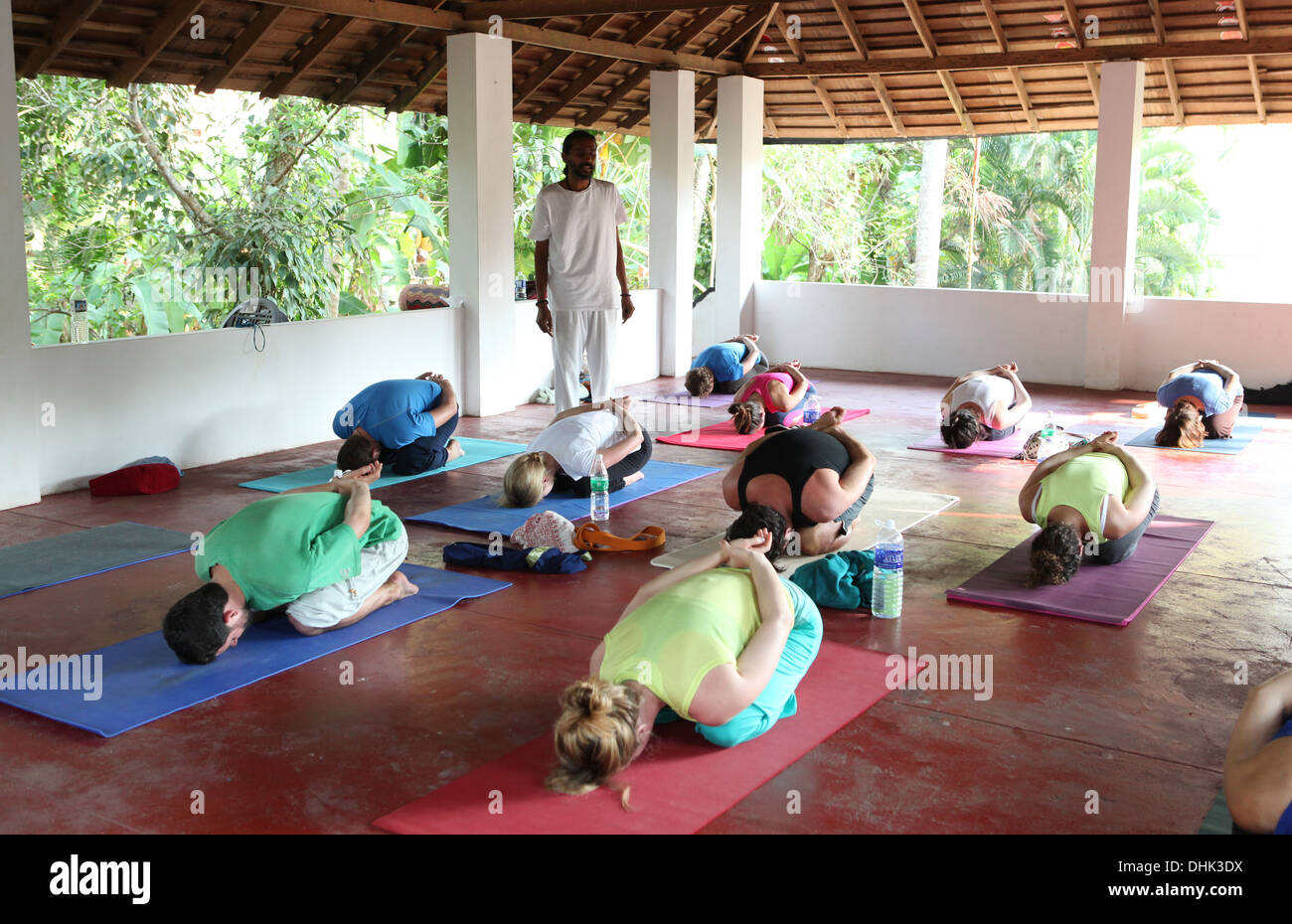 Yoga teacher and class during an exercise Stock Photo