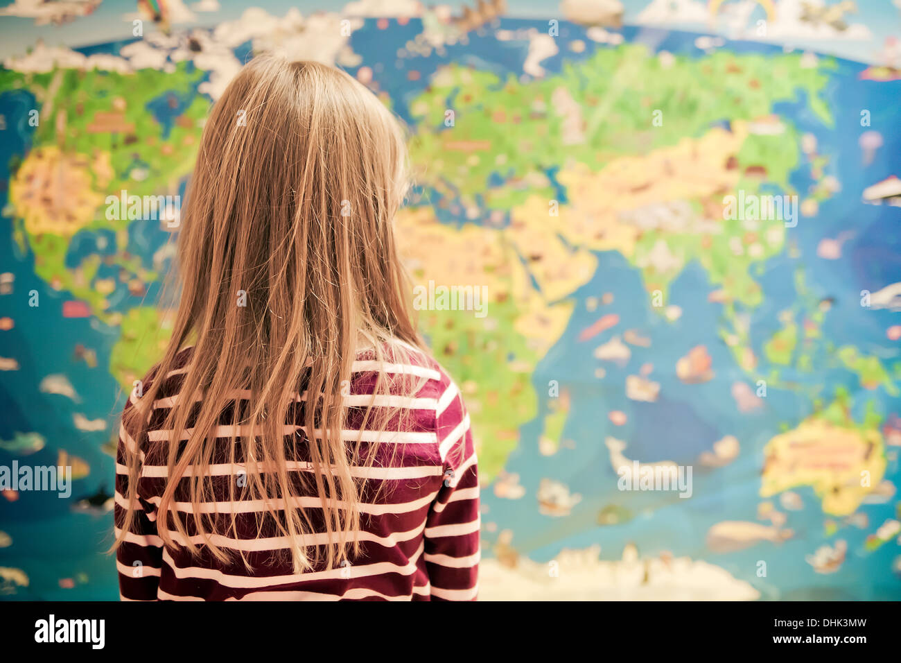Girl in front of world map Stock Photo