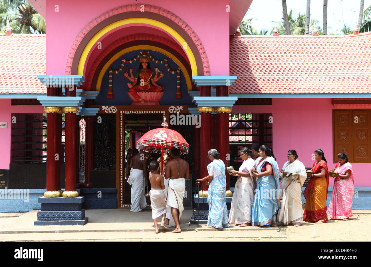 A group of women with offerings and a priest circling a Hindu temple in Varkala, India, Stock Photo