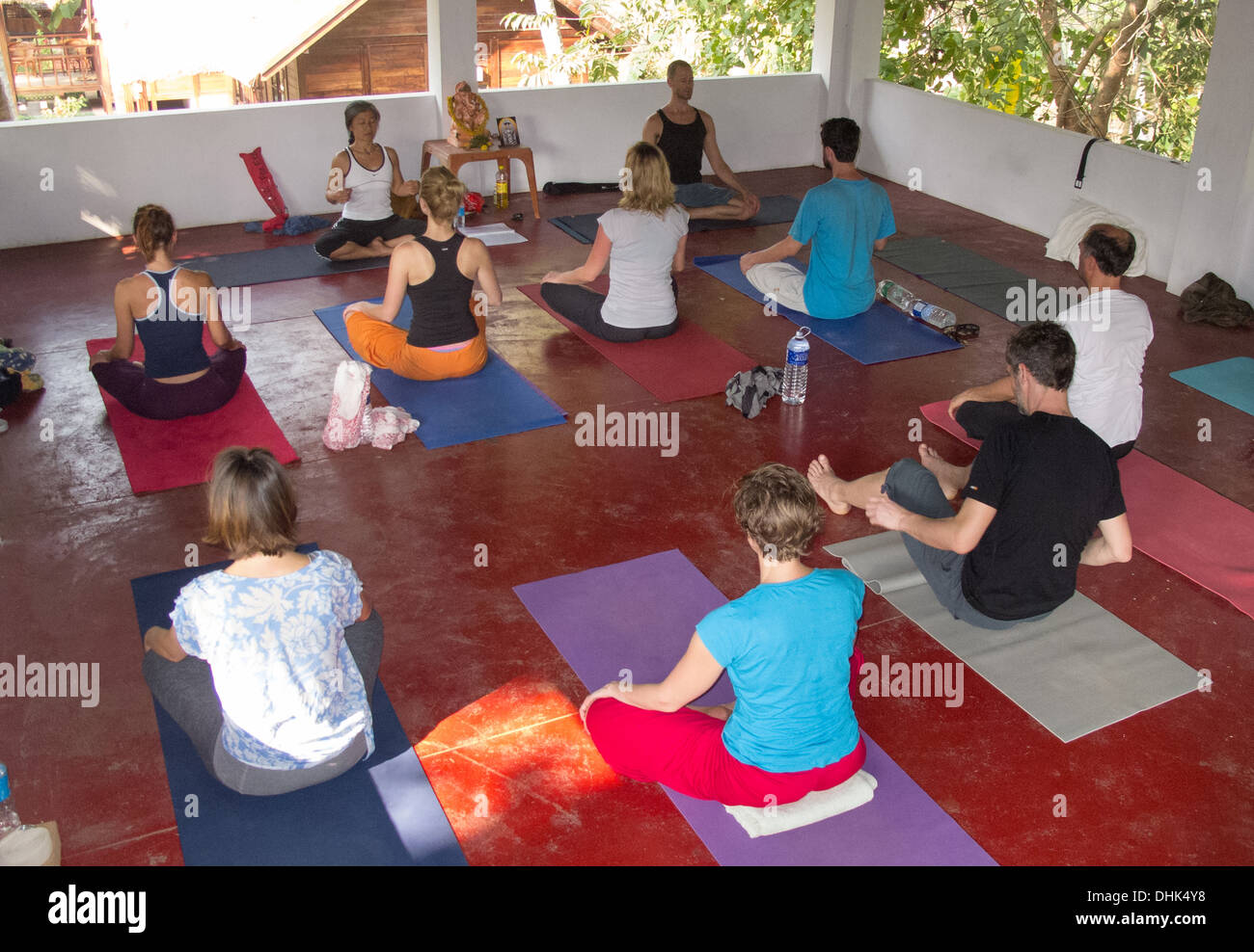 Yoga teacher and class during an exercise Stock Photo