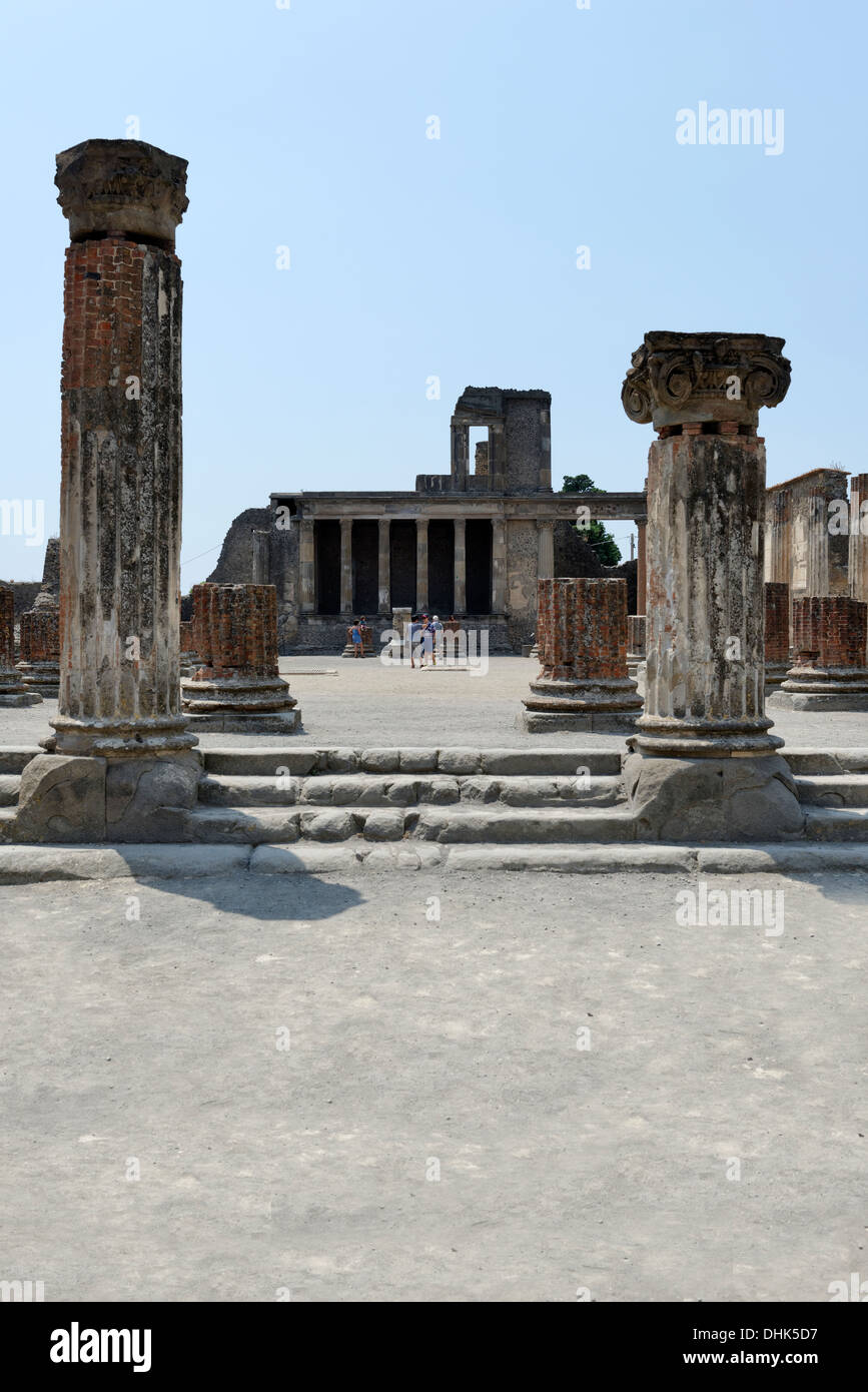 Part view of the Basilica with the elegant Hellenistic styled two-level Tribunal in the background at Pompeii Italy. Stock Photo