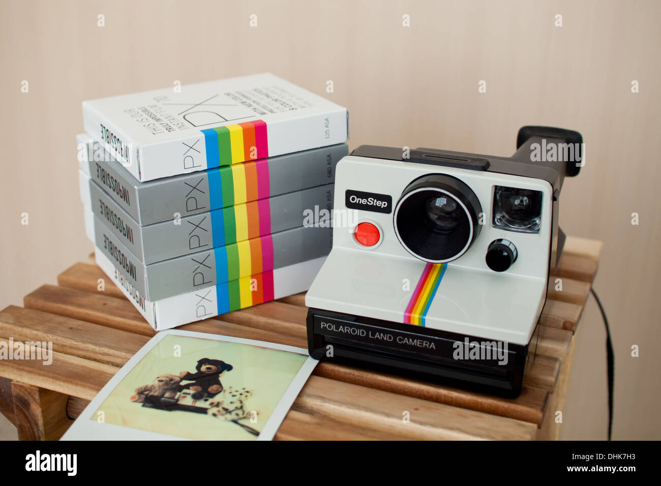 A white, rainbow stripe Polaroid camera (Polaroid Onestep), Impossible  Project film, and a Polaroid picture Stock Photo - Alamy