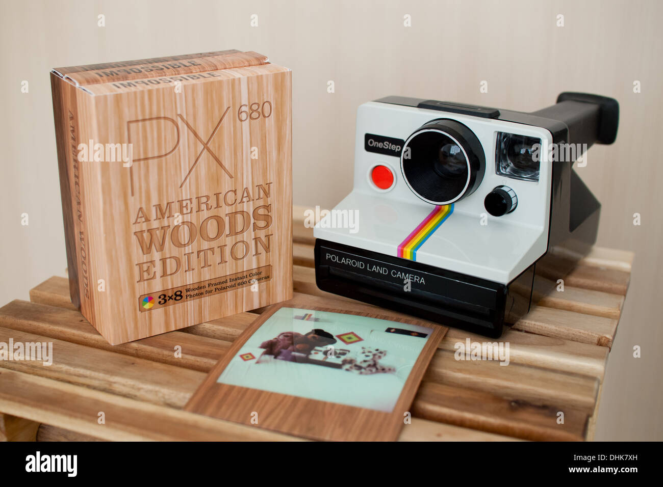 A white, rainbow stripe Polaroid Onestep camera and Impossible PX 680 Color  Protection American Woods Edition film Stock Photo - Alamy