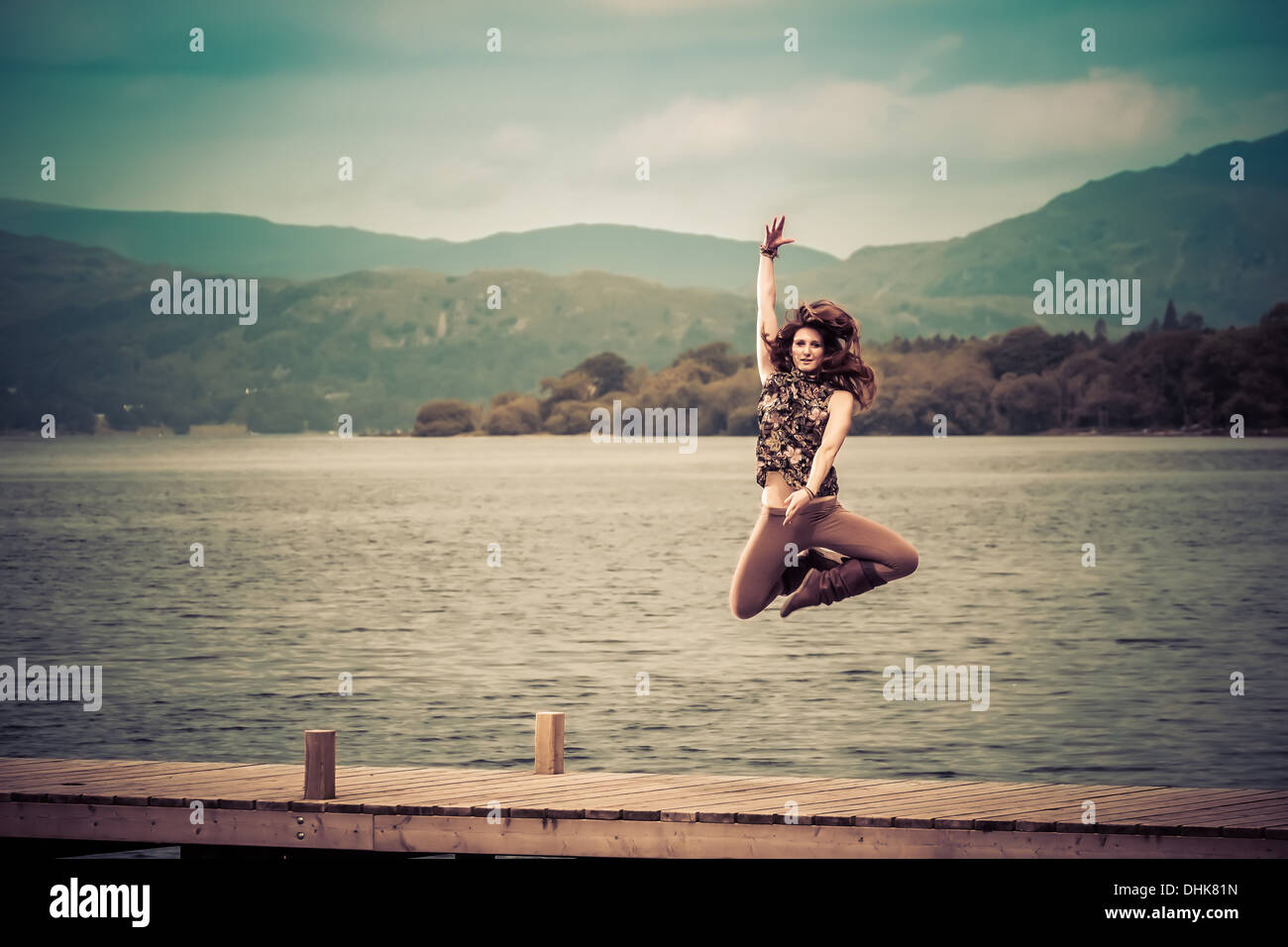 Dancer jumping on a jetty over Windermere Stock Photo