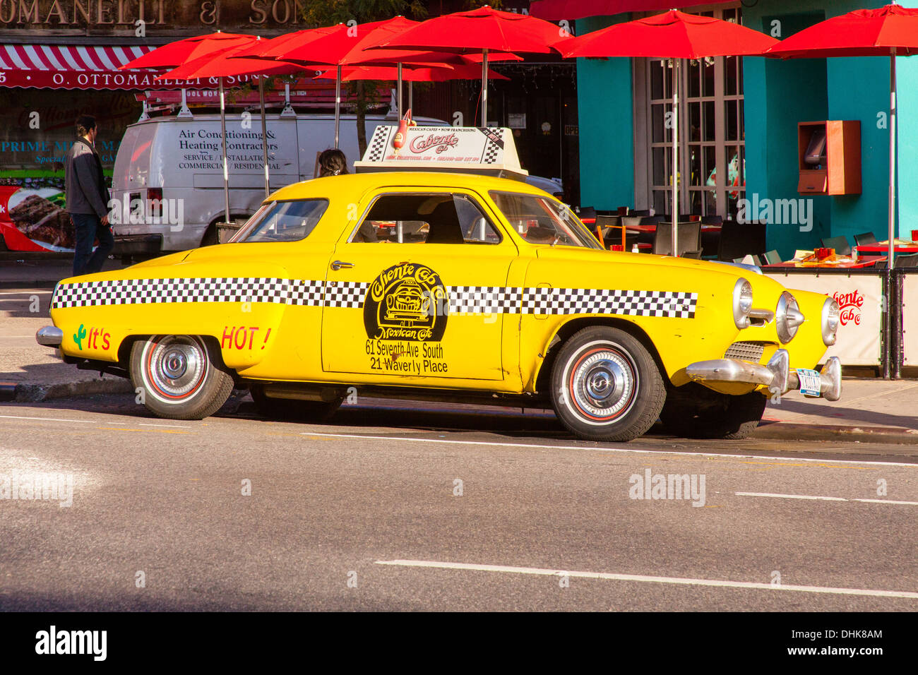 Vintage yellow taxi cab (1950's Studebaker) outside the Caliente Mexican restaurant, Greenwich Village, New York City, U.S.A Stock Photo