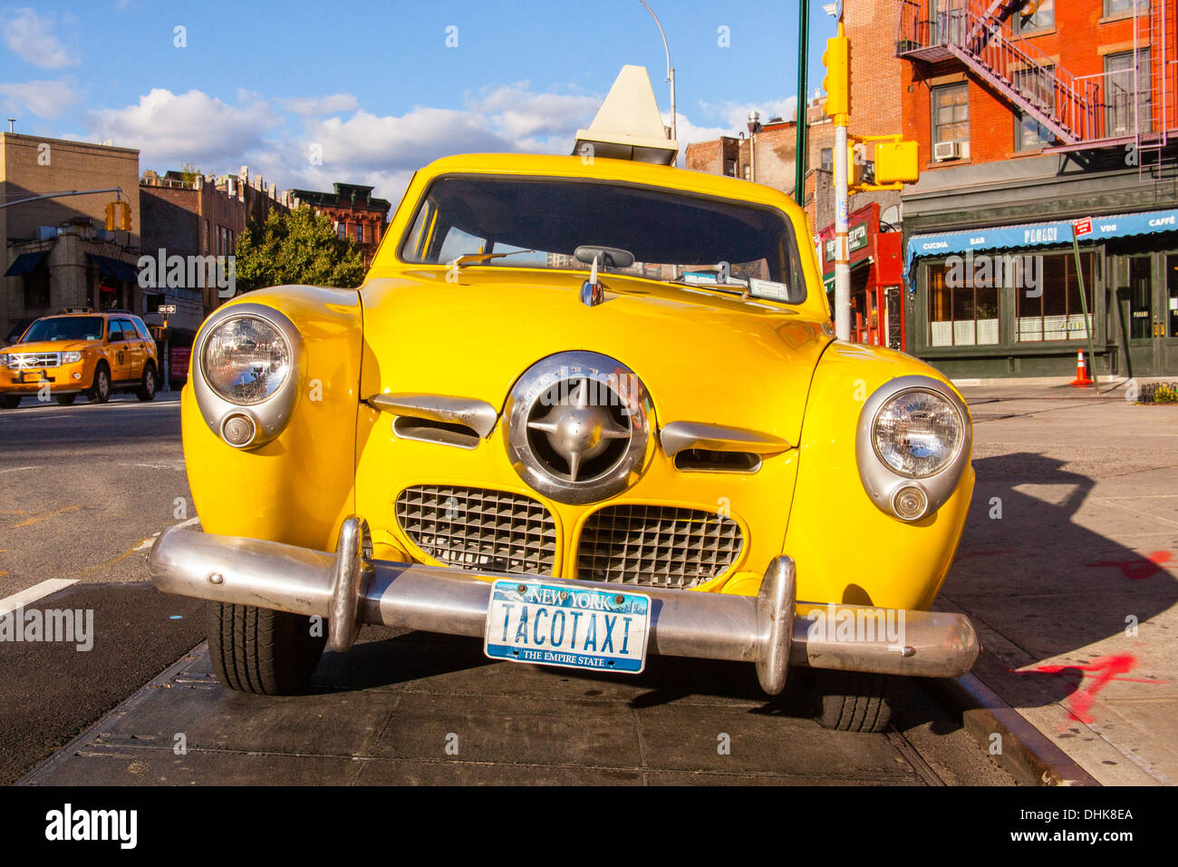 Vintage yellow taxi cab (1950's Studebaker) outside the Caliente Mexican restaurant, Greenwich Village, New York City, U.S.A Stock Photo