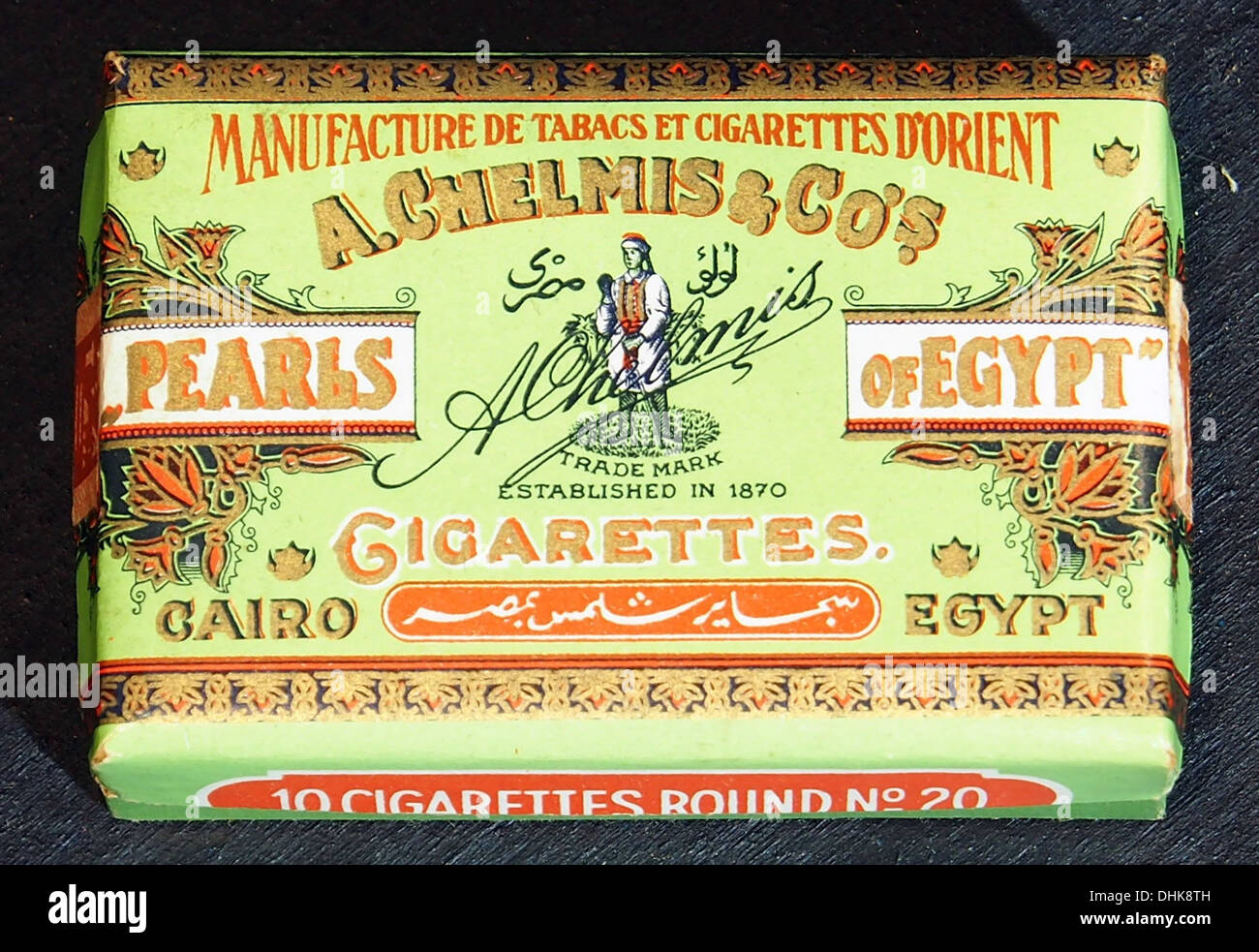A pack of 'Pearls of Egypt' cigarettes by A Chelmis & Co, featuring a  classic tobacco packaging design. This historical item reflects the  cigarette industry's global influence and packaging design trends Stock