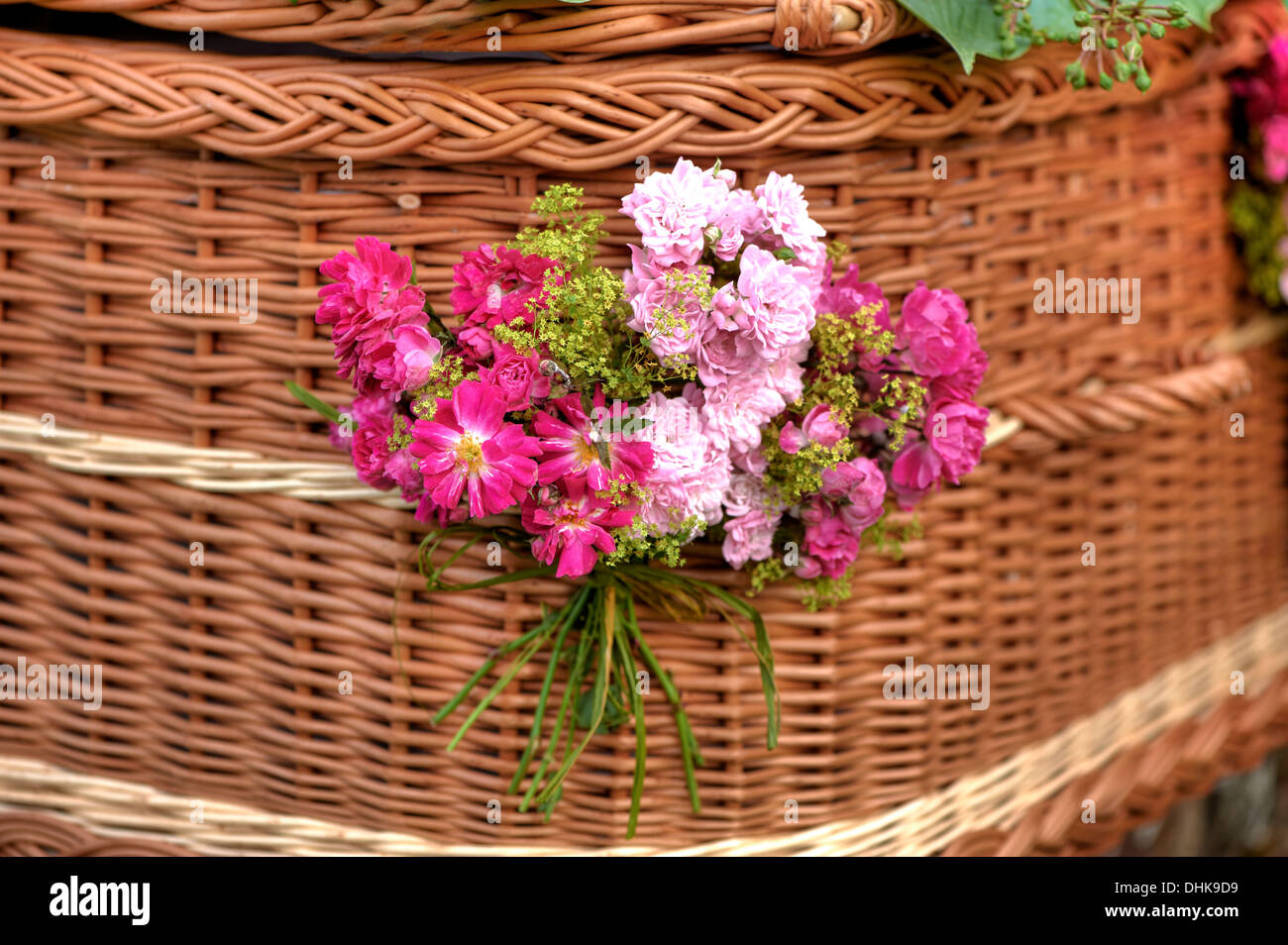 Wicker coffin with flower decoration Stock Photo Alamy
