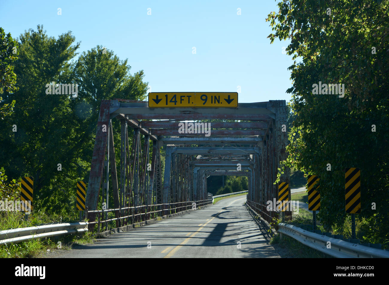 Old truss girder box bridge crosses a river on old Route 66 in rural Missouri, USA, with 14' 9' height restriction sign Stock Photo