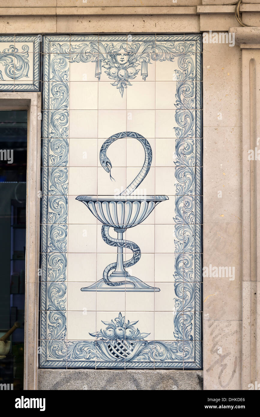 Tiles outside pharmacy showing the Bowl of Hygieia pharmacist's symbol of snake and cup, Madrid, Spain Stock Photo