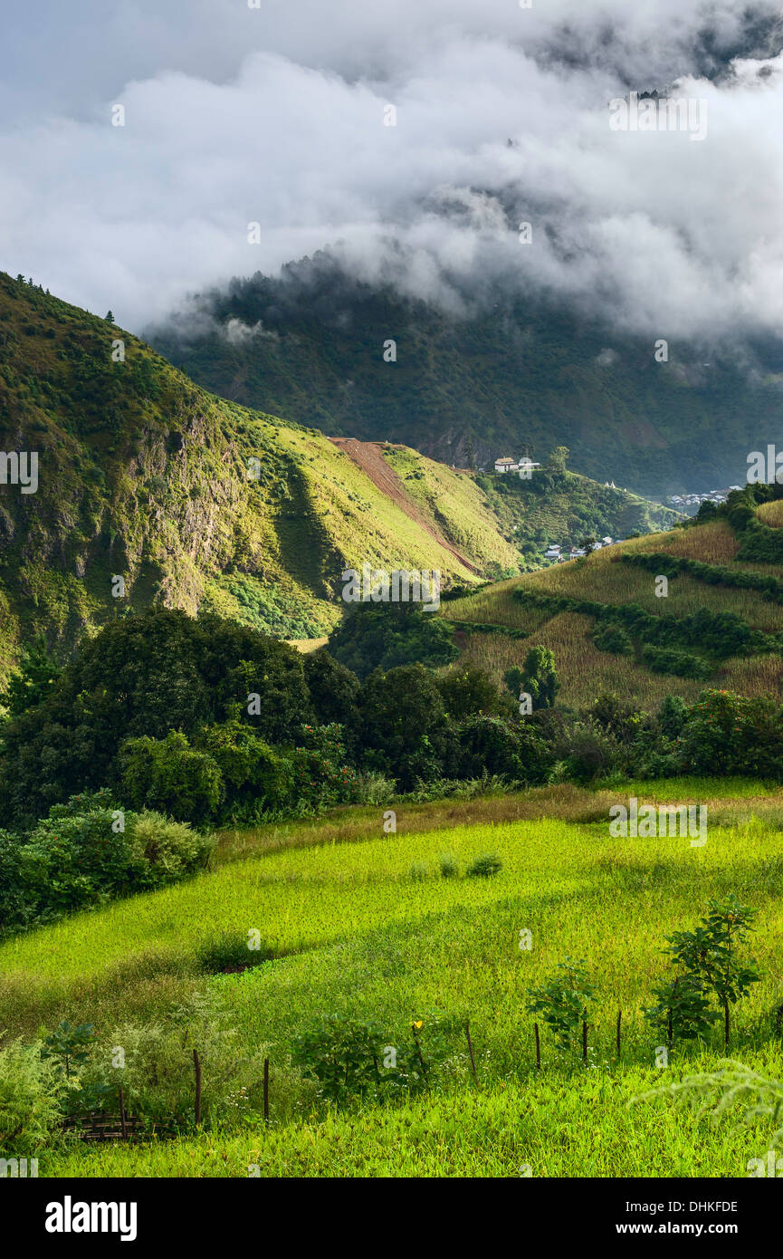 High mountains and village settlement shrouded in cloud at dawn near Tawang, western Arunachal Pradesh, India. Stock Photo