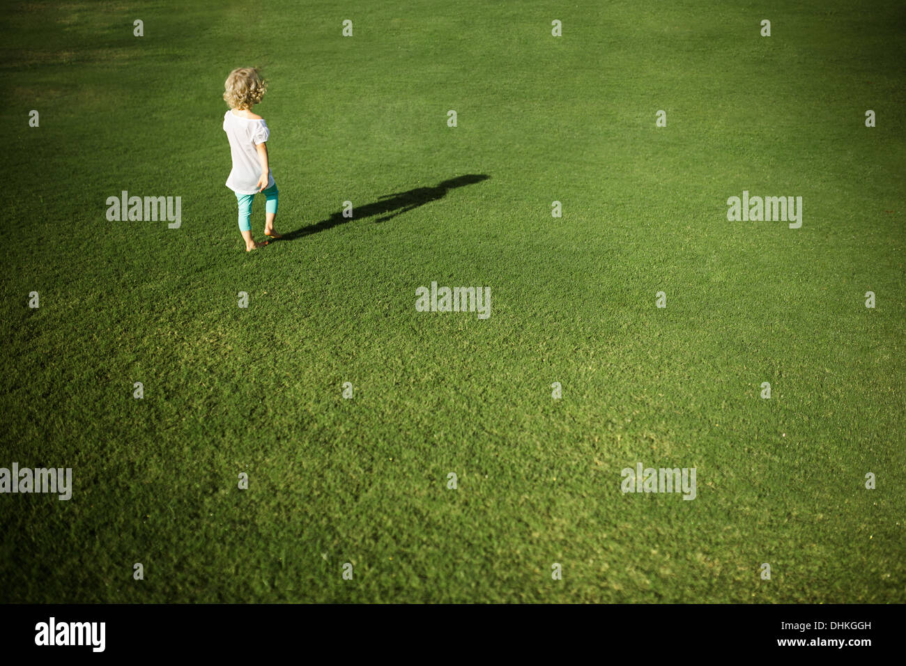 Little girl walking in the field Stock Photo - Alamy