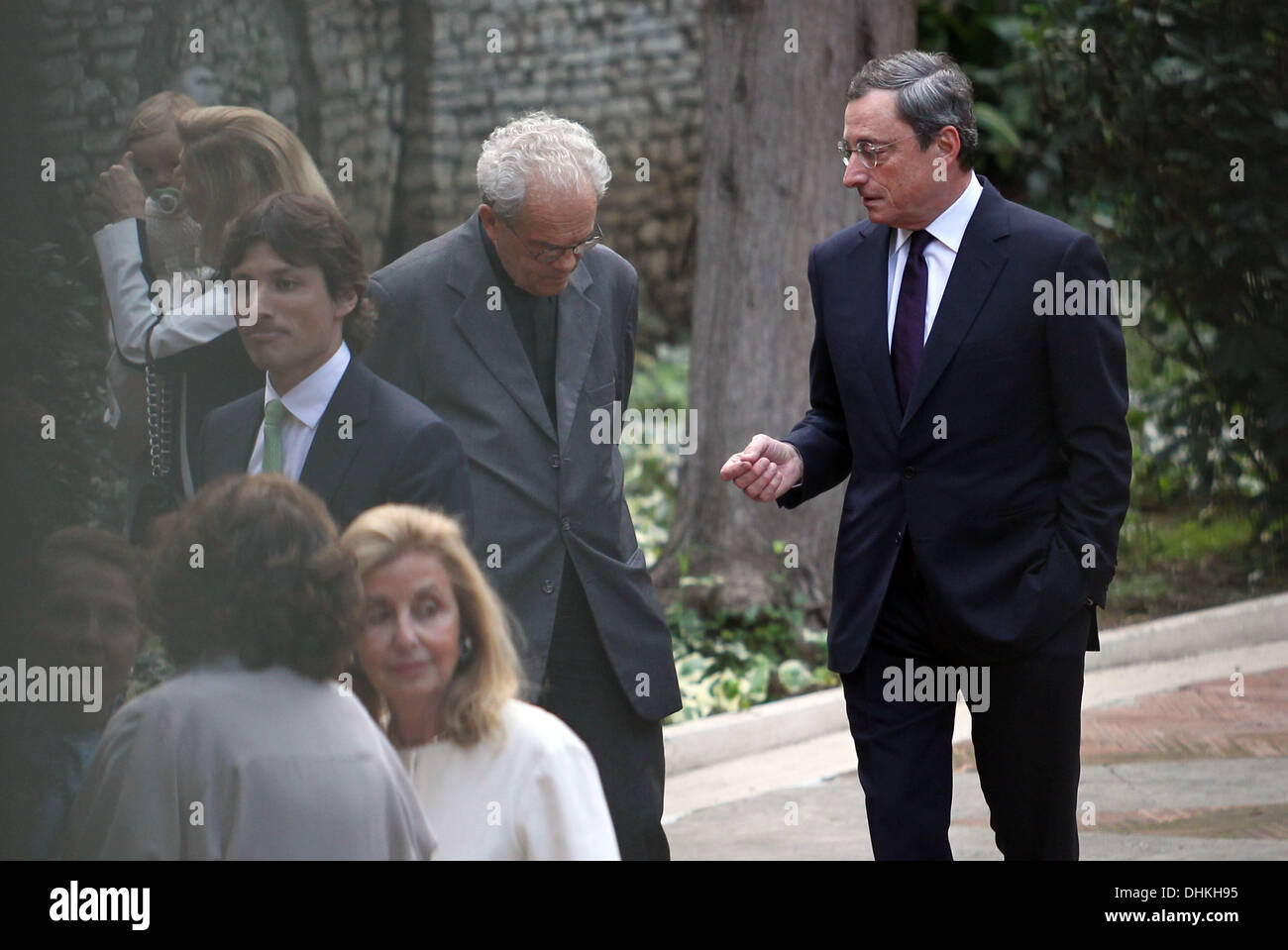 Roma Mario Draghi, President of the European Central Bank from 1 November 2011, with his family, his wife Serena Hat (white coat) and his son James, participating in the naming ceremony of his nephew in the church of St. Agnes in Rome.  Mario Draghi speaks before the ceremony with a priest and confess it seems.  Stock Photo