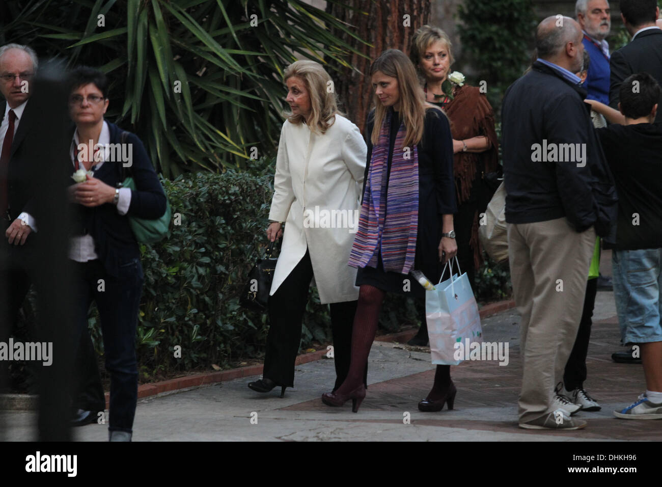 Roma Mario Draghi, President of the European Central Bank from 1 November 2011, with his family, his wife Serena Hat (white coat) and his son James, participating in the naming ceremony of his nephew in the church of St. Agnes in Rome.  Mario Draghi speaks before the ceremony with a priest and confess it seems.  Stock Photo