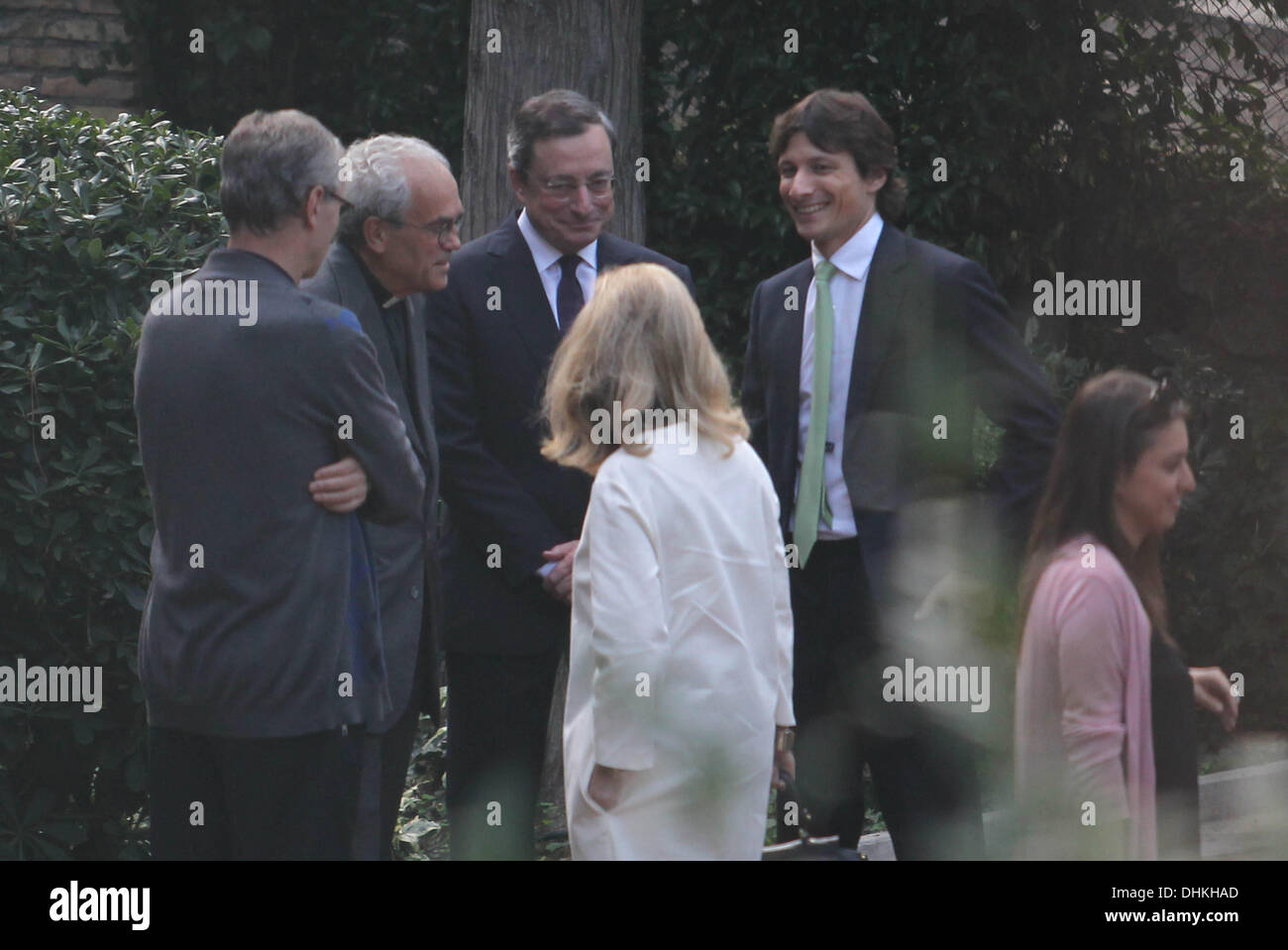 Roma Mario Draghi, President of the European Central Bank from 1 November 2011, with his family, his wife Serena Hat (white coat) and his son James, participating in the naming ceremony of his nephew in the church of St. Agnes in Rome.  Mario Draghi speaks before the ceremony with a priest and confess it seems.  Stock Photo