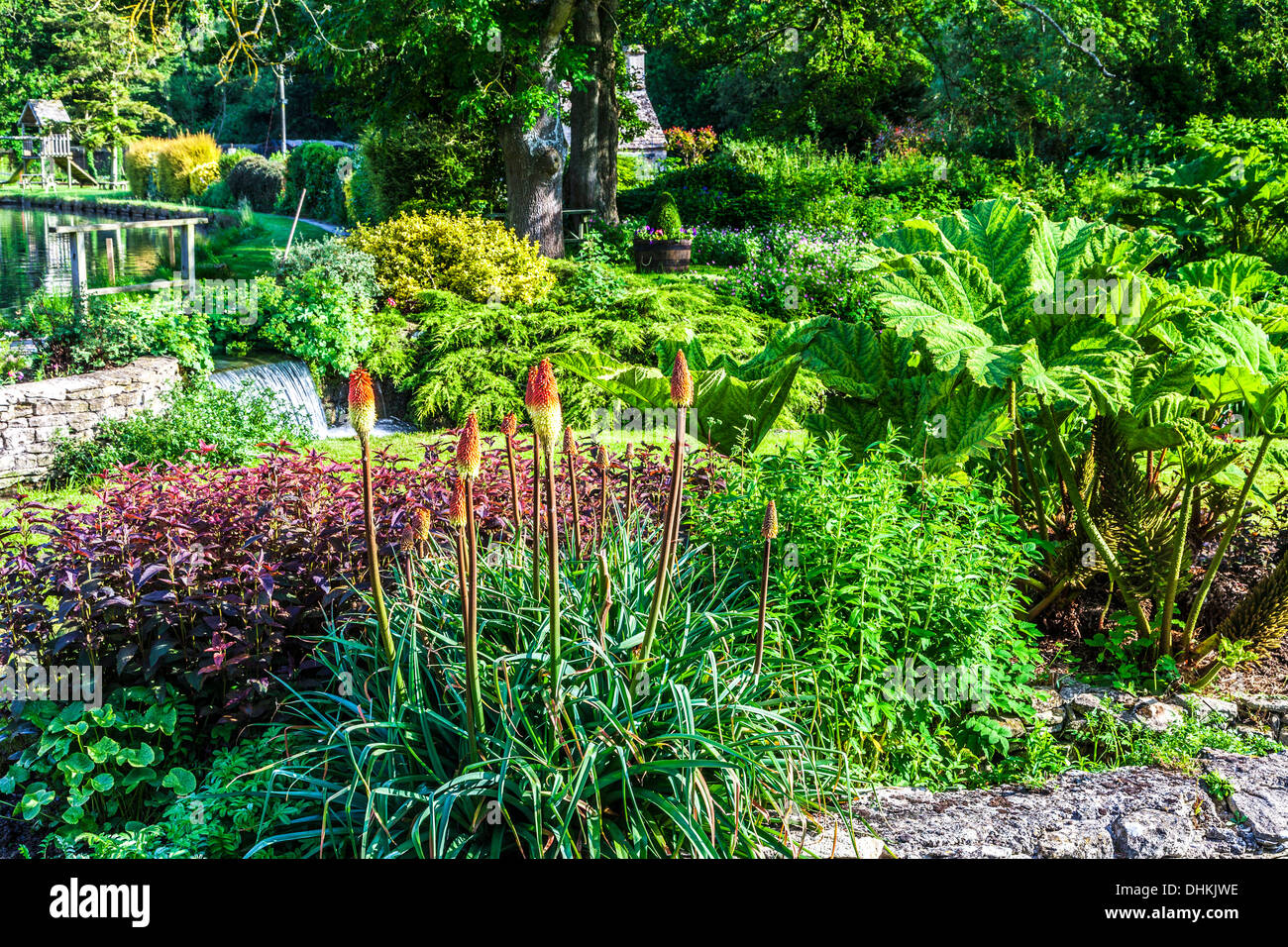 The pretty landscaped garden of the Trout Farm in the Cotswold village of Bibury in the Coln Valley. Stock Photo