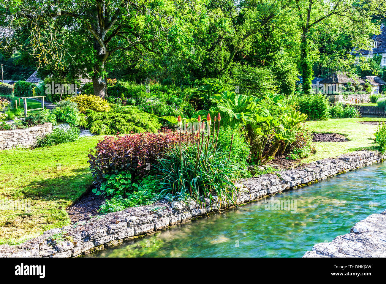 The pretty landscaped garden of the Trout Farm in the Cotswold village of Bibury in the Coln Valley. Stock Photo
